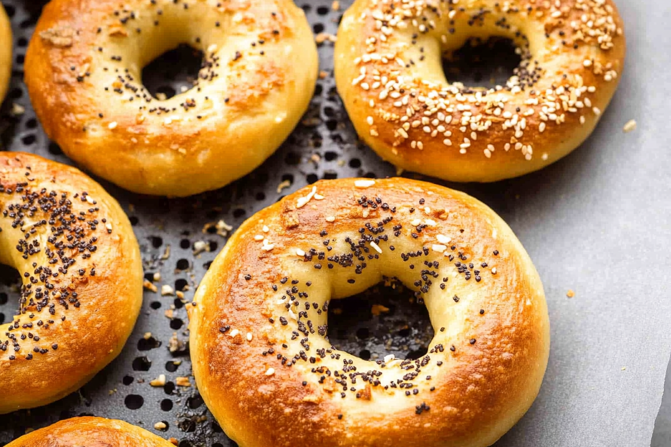 Mixing ingredients for air fryer bagel dough in a glass bowl.